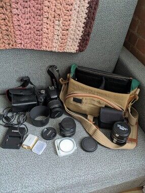 Canon T1i camera sat with zoom lens, 50mm prime, macro extension tubes, and more